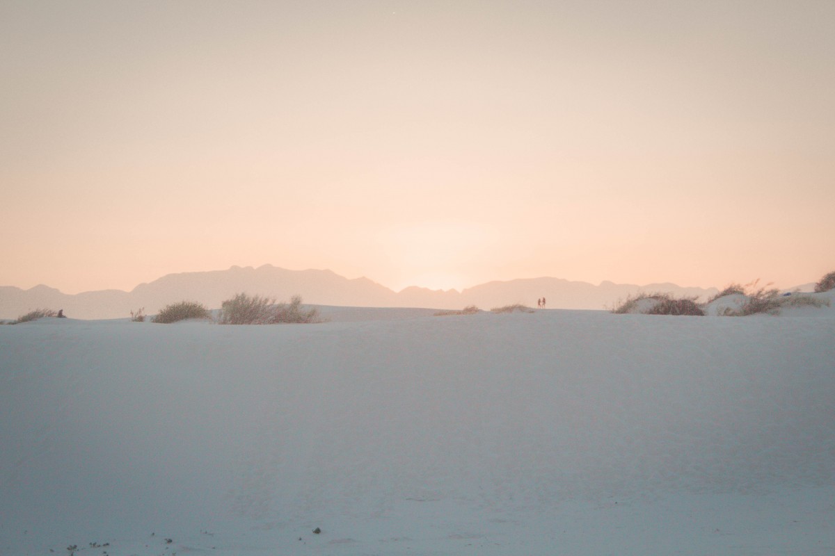 a gorgeous soft orange sunset seen while visiting White Sands National Park