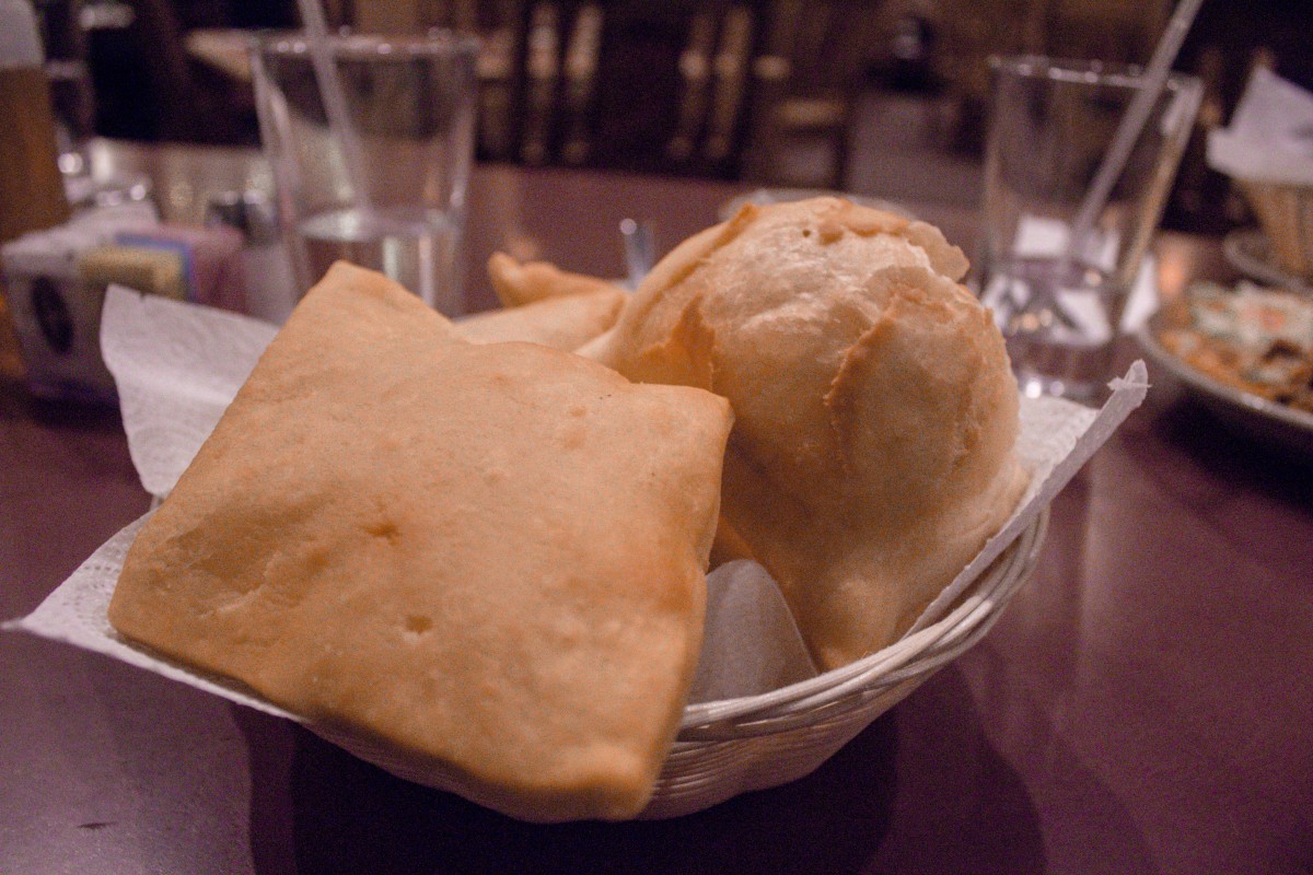 Sopapillas in a basket of different shapes and sizes. Sopapillas are traditional New Mexican foods. 