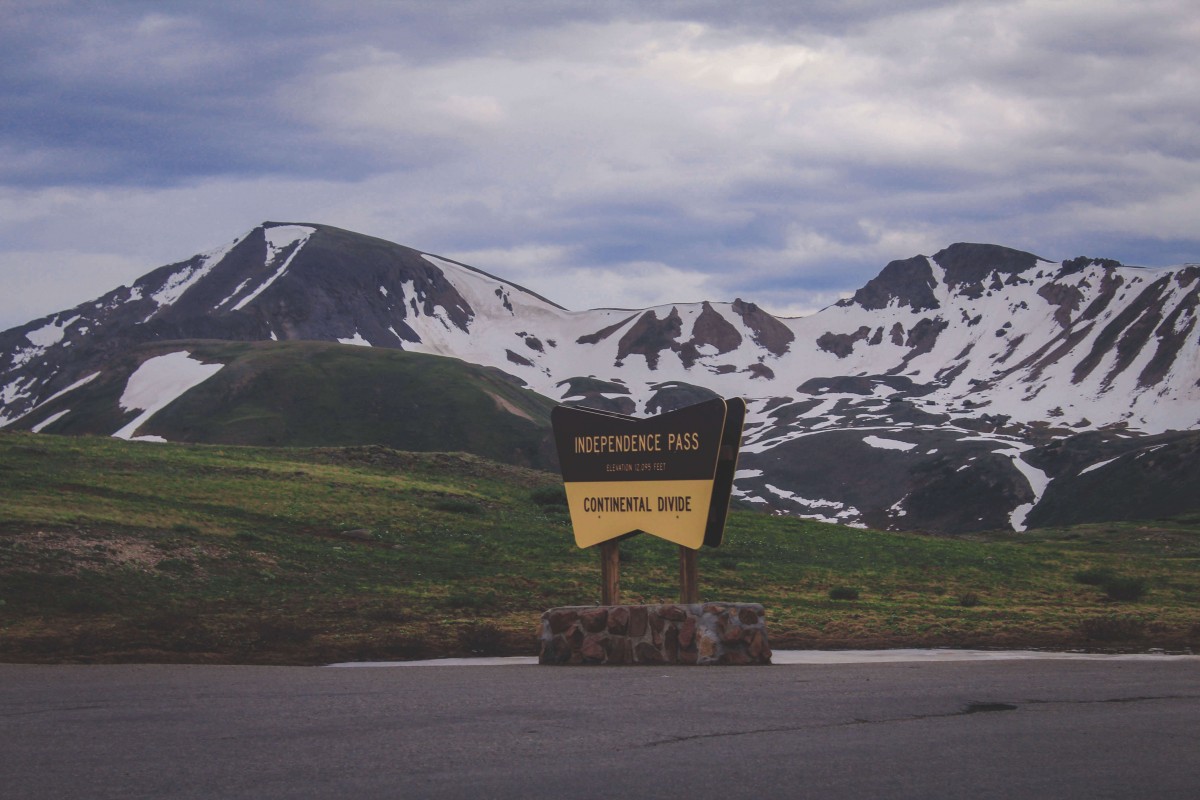 a photo of the Continental Divide location marker and sign along Independence Pass 