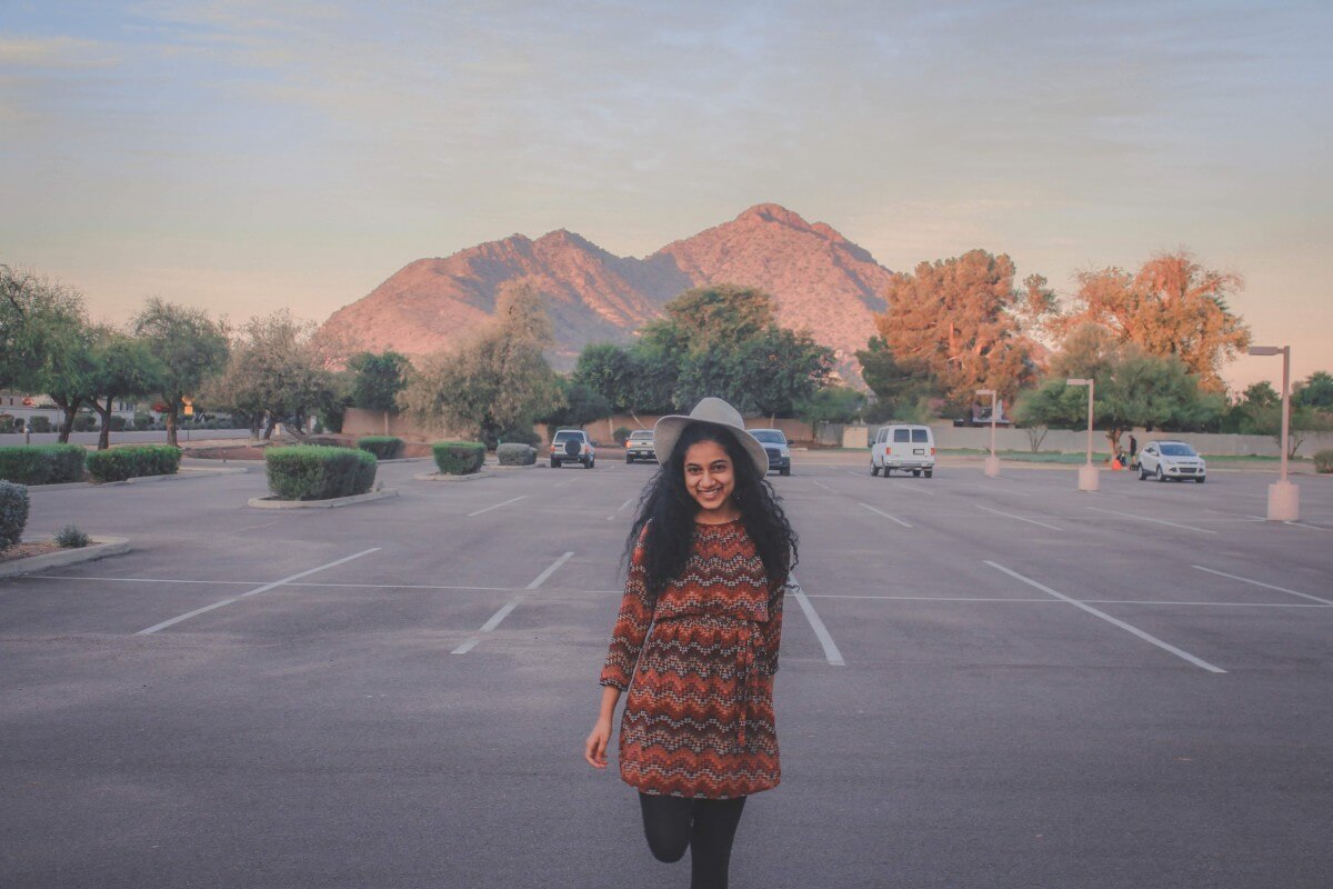 I'm standing in front of Camelback Mountain at sunrise in an empty parking lot.