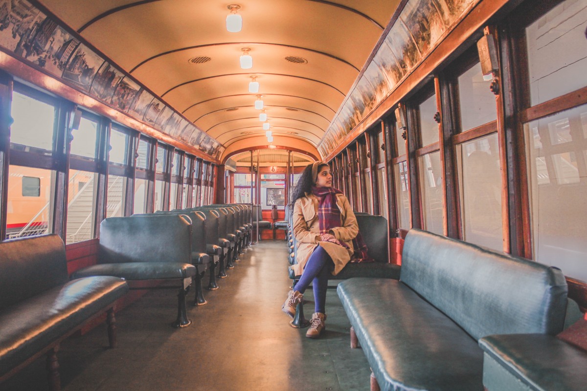 Anshula sitting in an old Union Station railcar