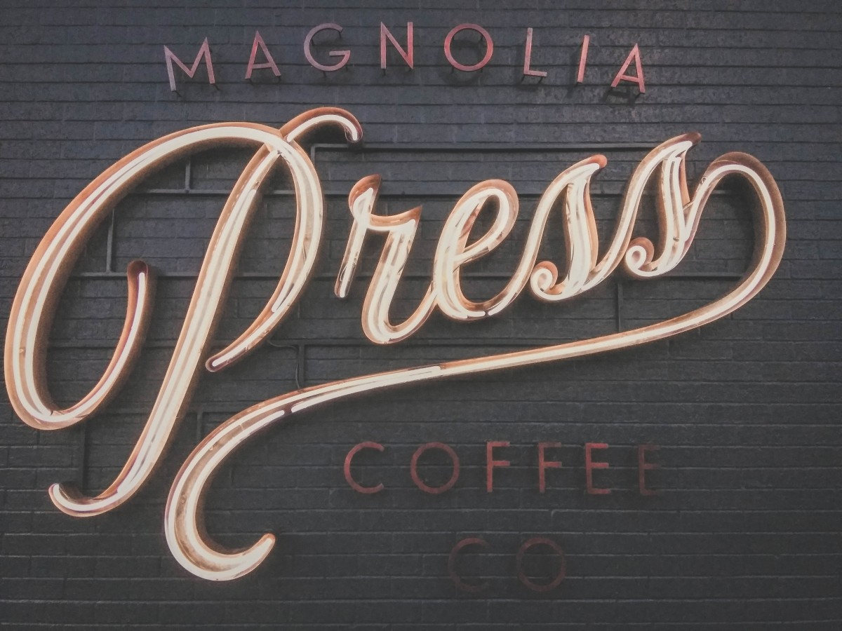 Coffee Shops In Waco - sign outside of Mangolia Press Coffee