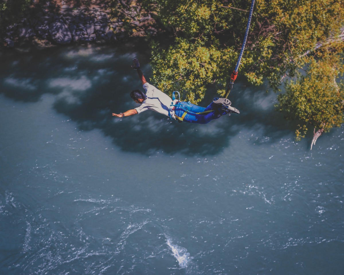 photo of man bunjee jumping as featured photo for adventurous road trip questions for couples