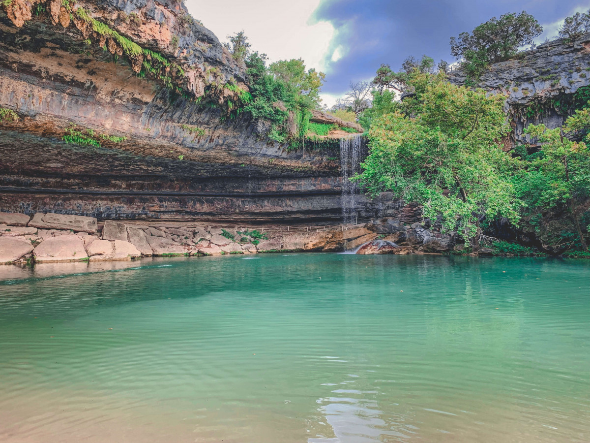 a day trip from Austin, Hamilton Pool with its stunning waterfall and stunning waters is one of the prettiest places near Austin