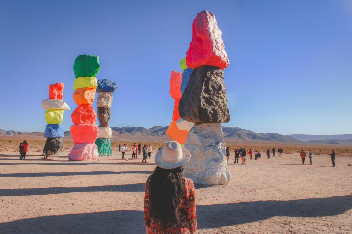 person standing in front of the colorful painted rocks near Vegas