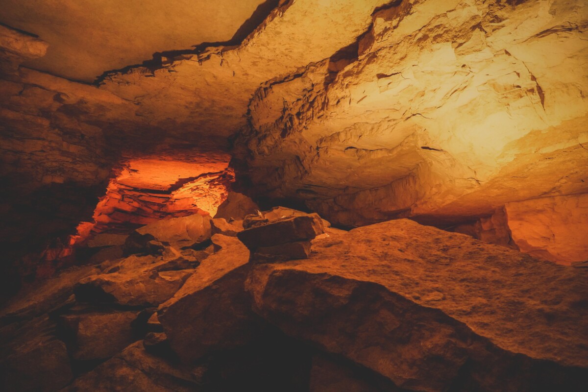 a dark, orange section of Mammoth Cave taken on the Domes & Dripstones tour
