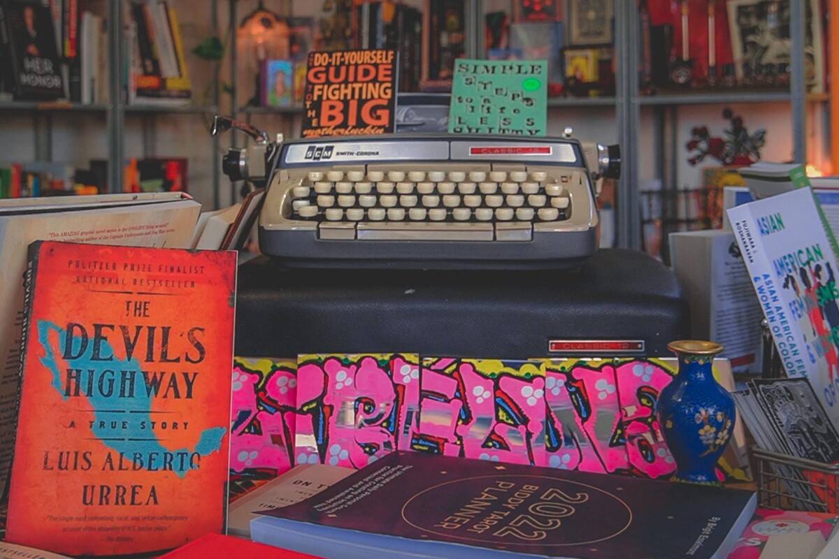 bookstores in San Diego: one of the display shelves of Libelula Books & Co featuring a typewriter and Chicanx and Asian nonfiction