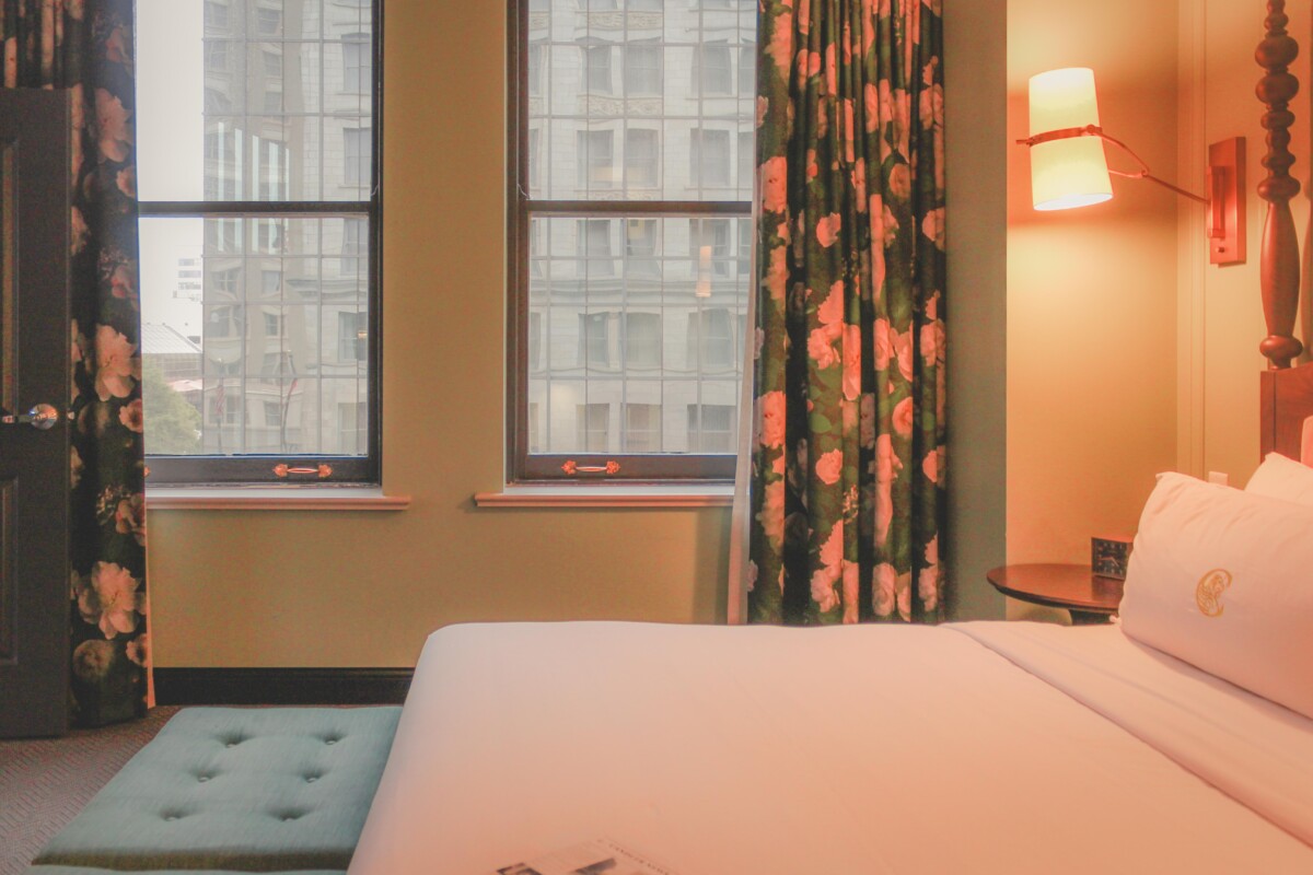 luxurious suite bedroom with magnolia curtains - The Candler hotel atlanta review