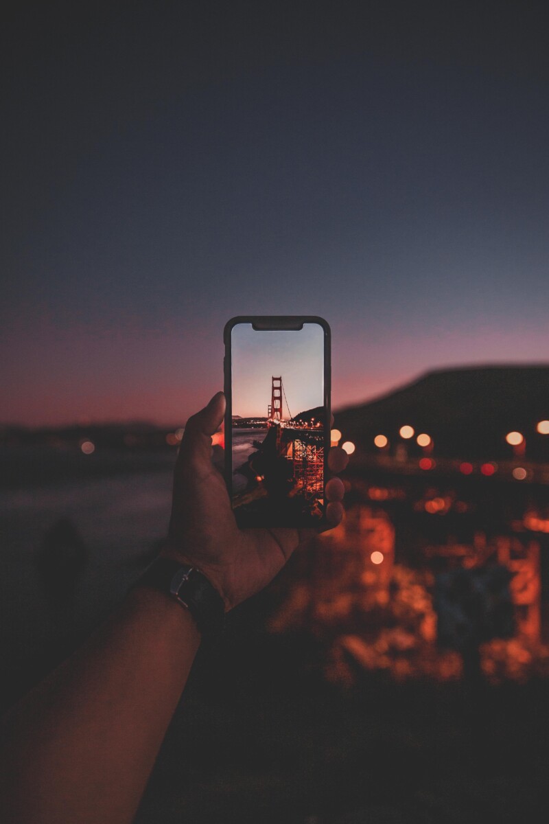 What To Pack For San Francisco: Miscellaneous featured photo of a phone held up to Golden Gate Bridge to show tech to bring to San Francisco