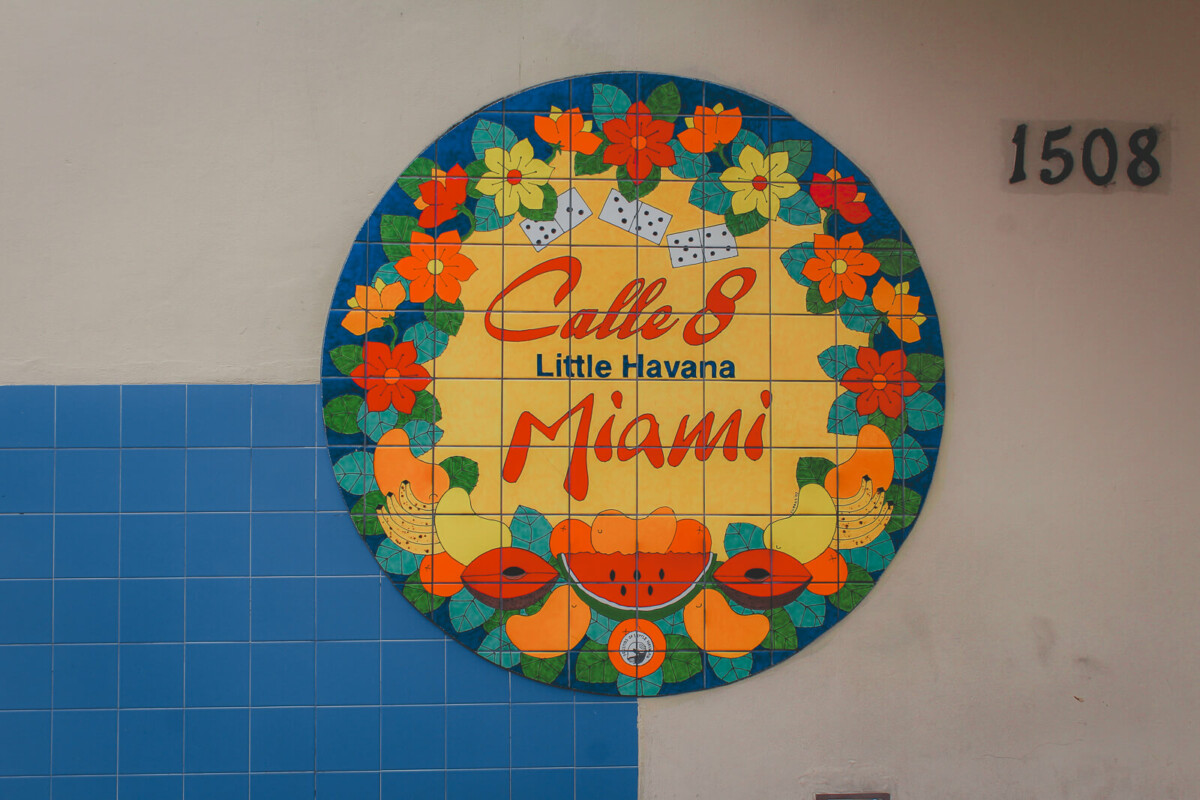 beautiful tiled circle sign (with flowers and dominoes and fruit) that says Calle 8 Little Havana Miami
