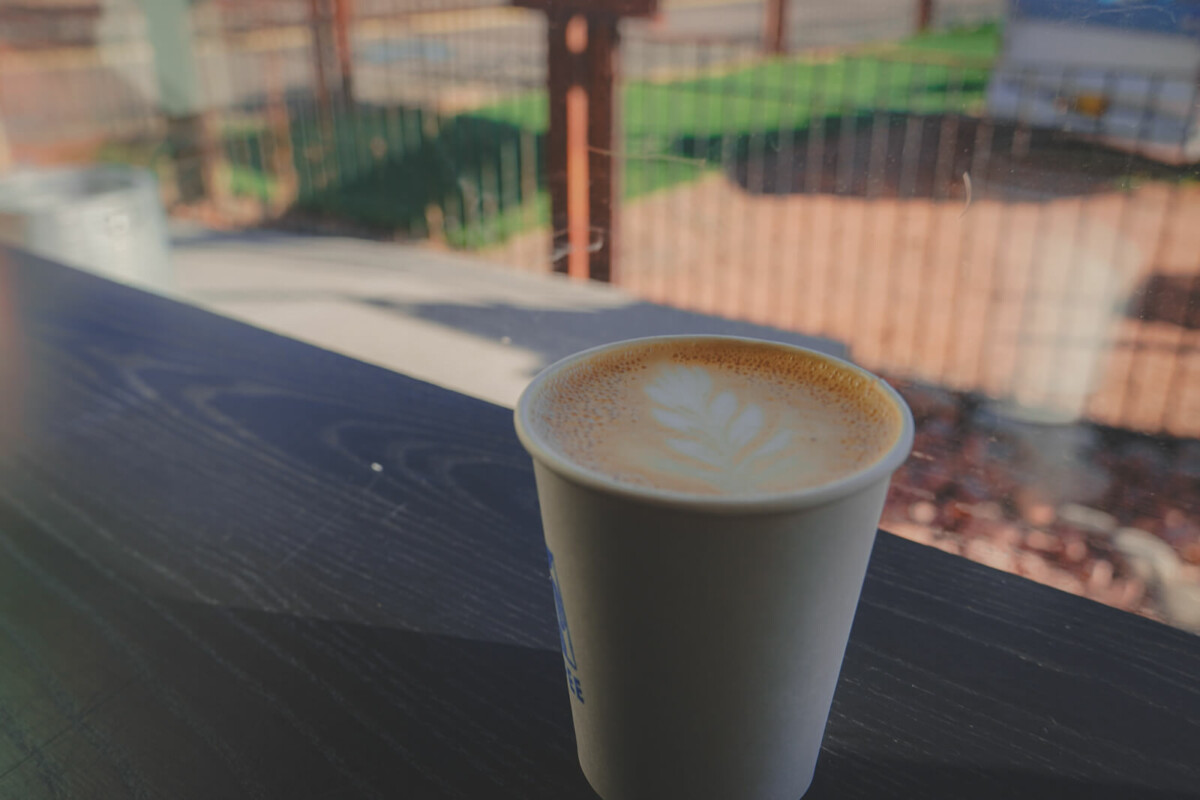 a cup of Sky coffee overlooking back views of The Railyard; Sky Coffee is one of the best coffee shops in Santa Fe for its views
