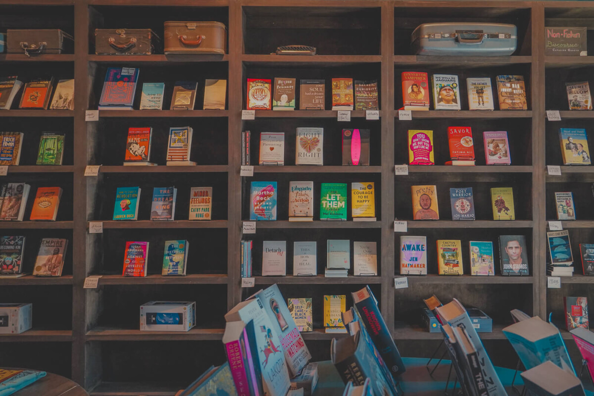 shelves of face-out books with suitcases and typewriters at Poets Bookstore, one of the most unique bookstores in Dallas