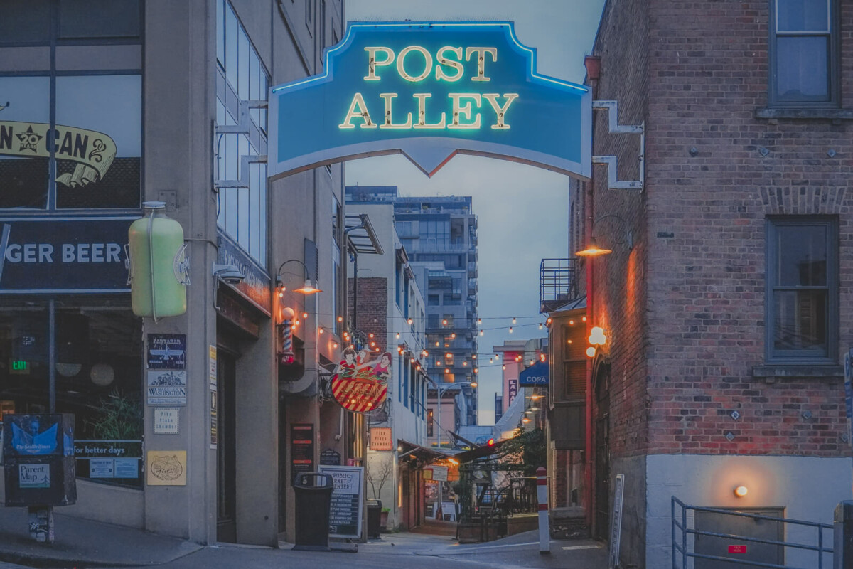 low-lit sign of Post Alley, one day of the places to see in Seattle in 24 hours