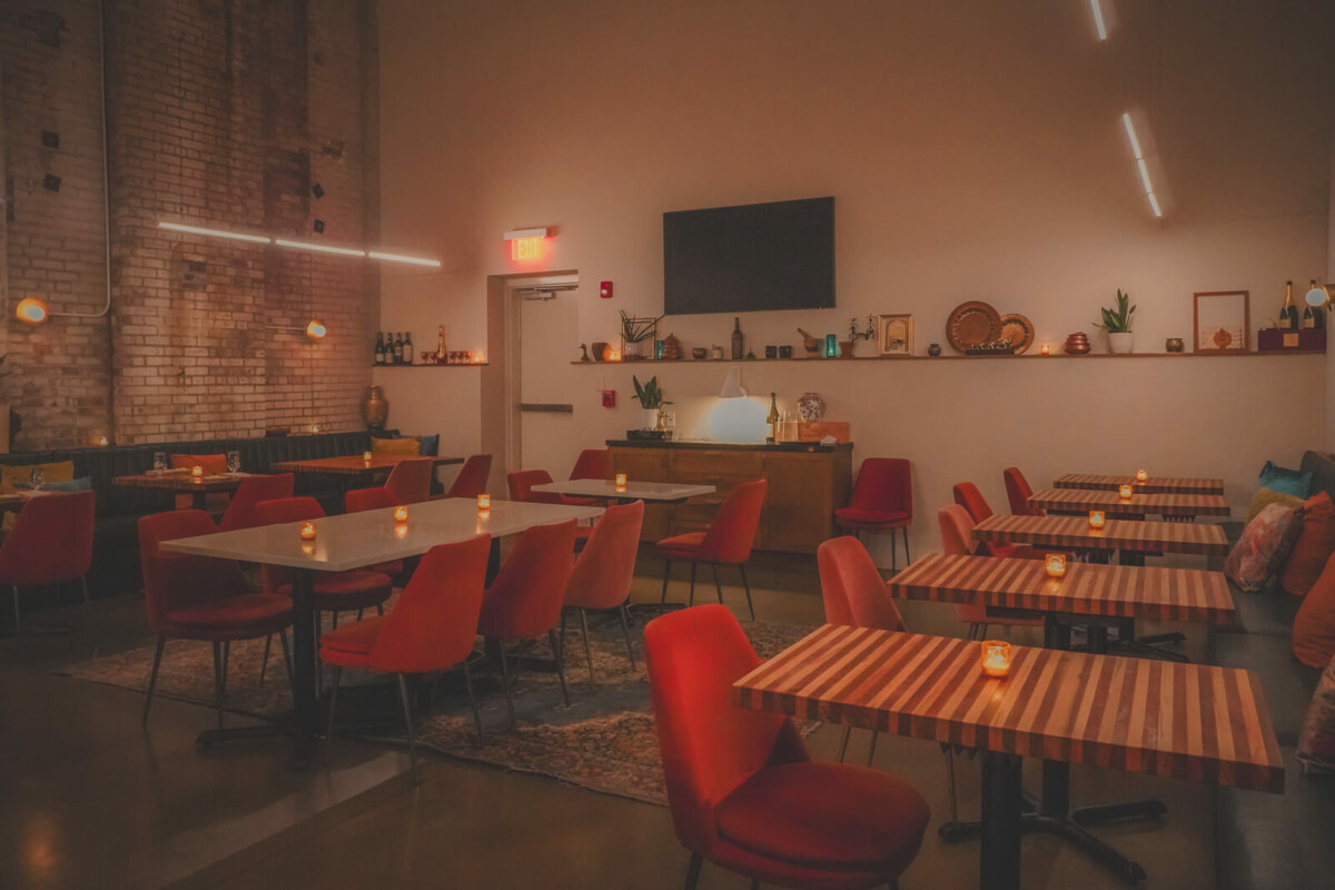 candelit tables for two at Tailor, one of the most romantic locations in Nashville at night for a dinner party vibe