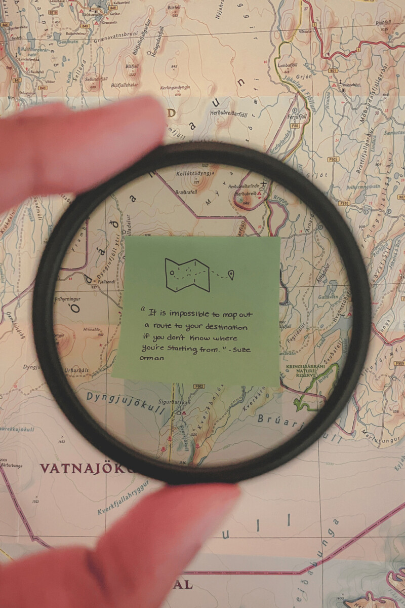 a short inspirational map quote on a sticky note atop a map of Iceland