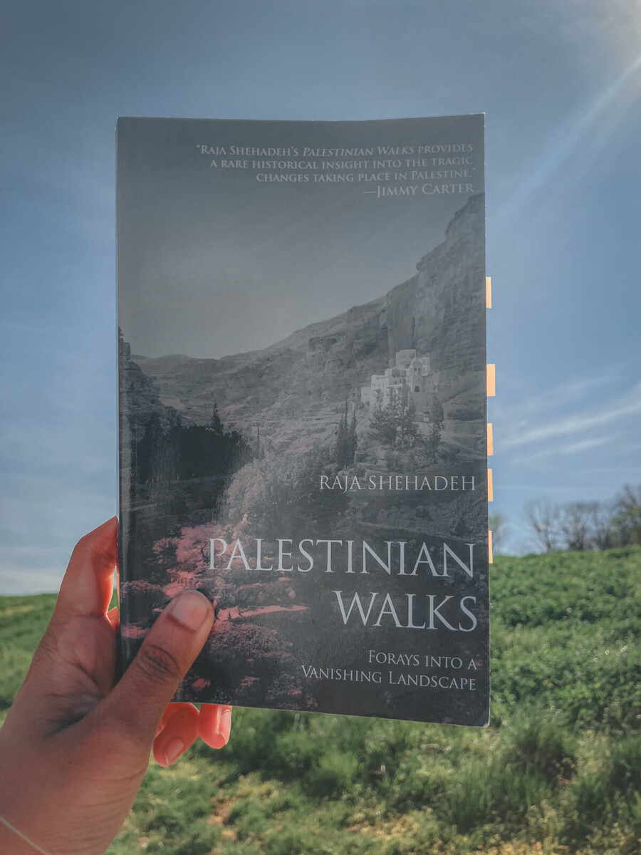 Eden Travel Book Club host holding a copy of the April 2026 Eden Travel Book Club Pick